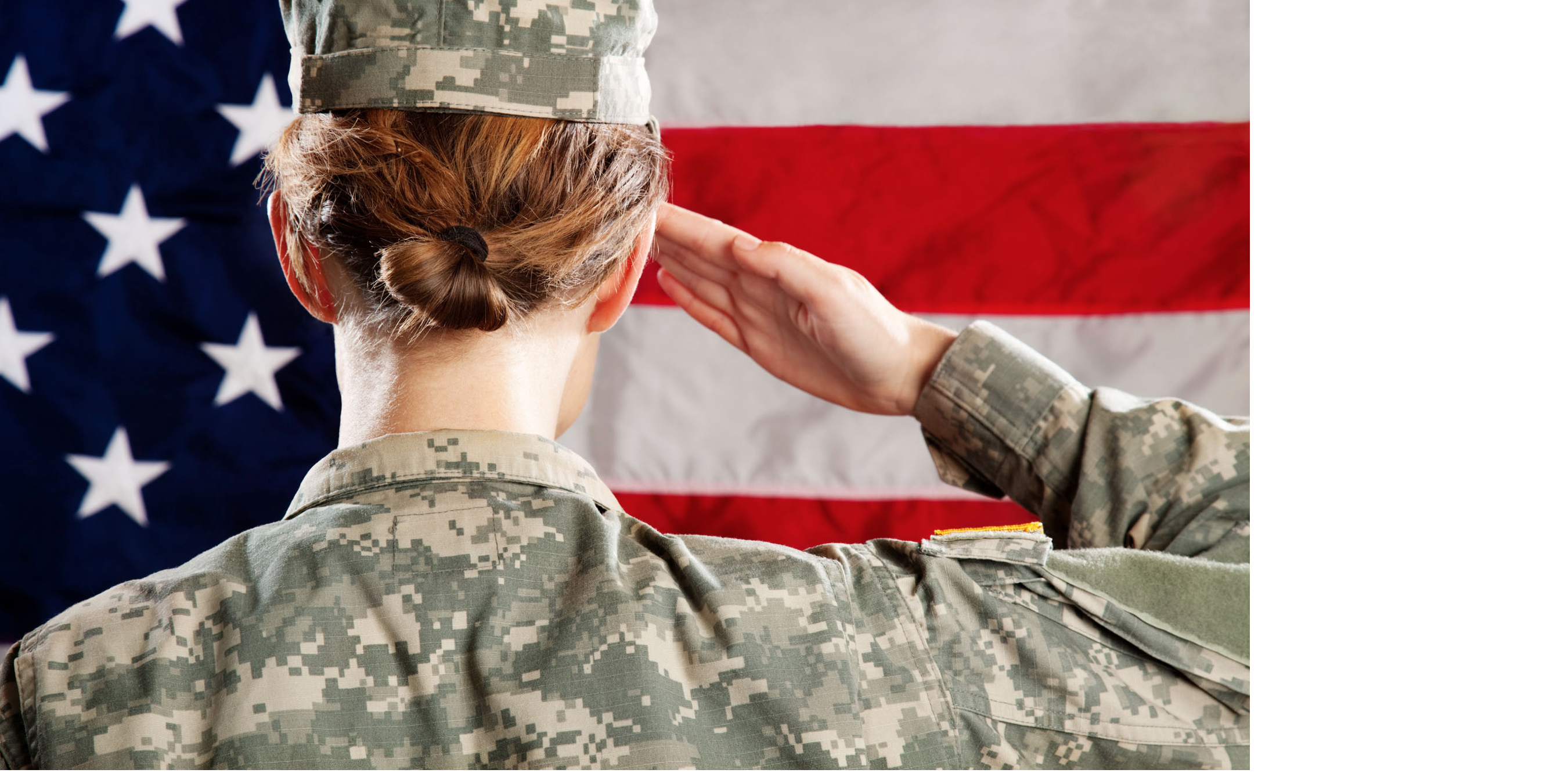 Woman saluting in front of flag