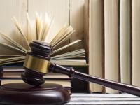 Gavel in front of books