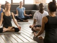 Woman and man seated in yoga pose