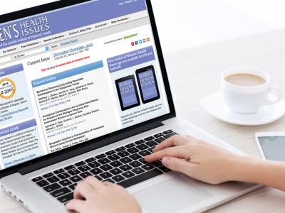 Woman's hands on keyboard of laptop displaying Women's Health Issues home page