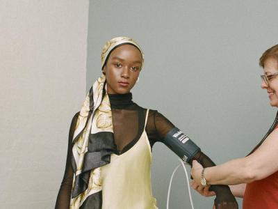 One woman takes another's blood pressure