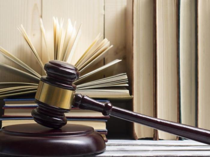 Gavel in front of books