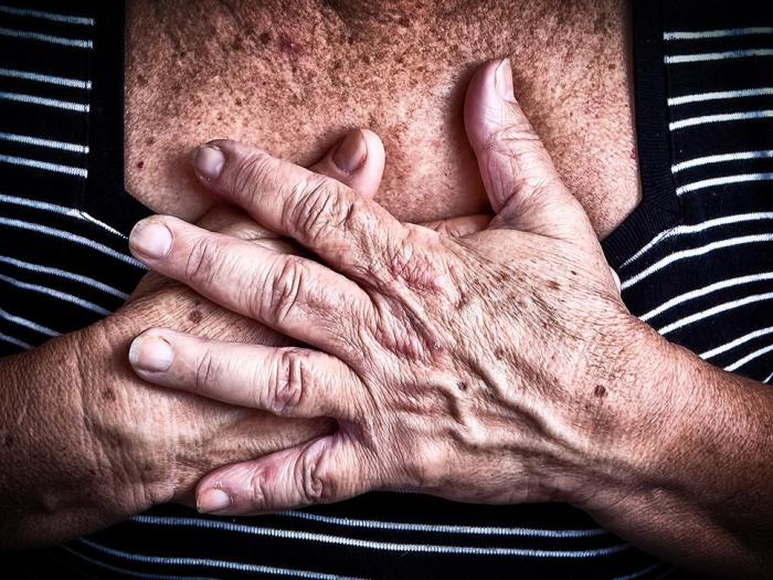 womans hands on chest
